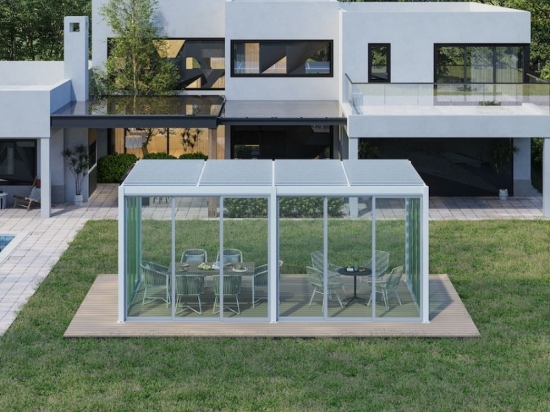 Glass Enclosed Pergola on timber platform featuring outdoor dining setup.