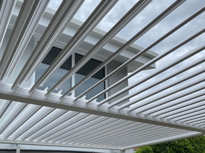 Close-up view of white pergola roof slats showing design factors affecting Pergola Permit requirements.