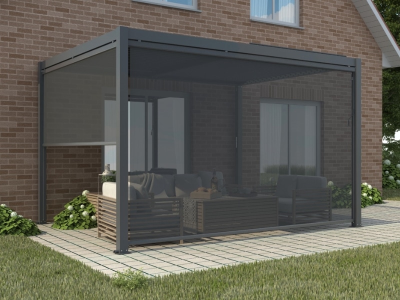 Backyard louvered pergola with mesh privacy screen illustrating enclosed types of pergolas for shaded outdoor living.