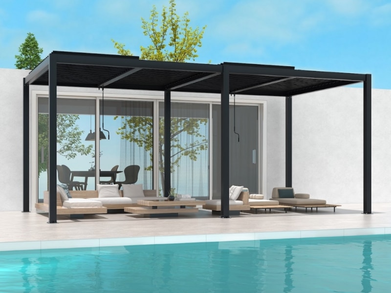 Poolside pergola ideas shown with modern black pergola shading lounge seating beside swimming pool.