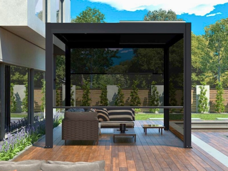 Best Pergola Material highlighted with black pergola over timber deck beside poolside lounge.