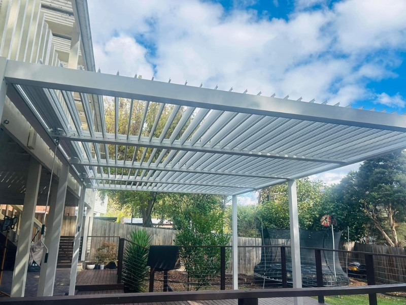 Vines On Pergola shown with large white louvre pergola in backyard ready for climbing plants.