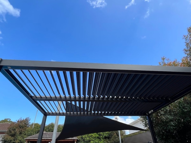 Motorised Pergola Pet Safety displayed with open louvres providing safe shaded area under clear sky.