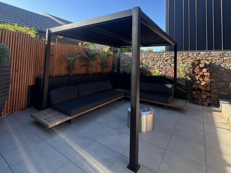 Best Season for Pergola highlighted by shaded outdoor lounge beneath sleek pergola in warm backyard.