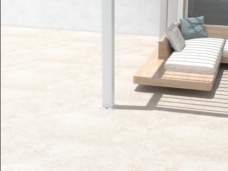 Anchor Pergola fixed to concrete with outdoor seating and cushions beneath modern white pergola post.