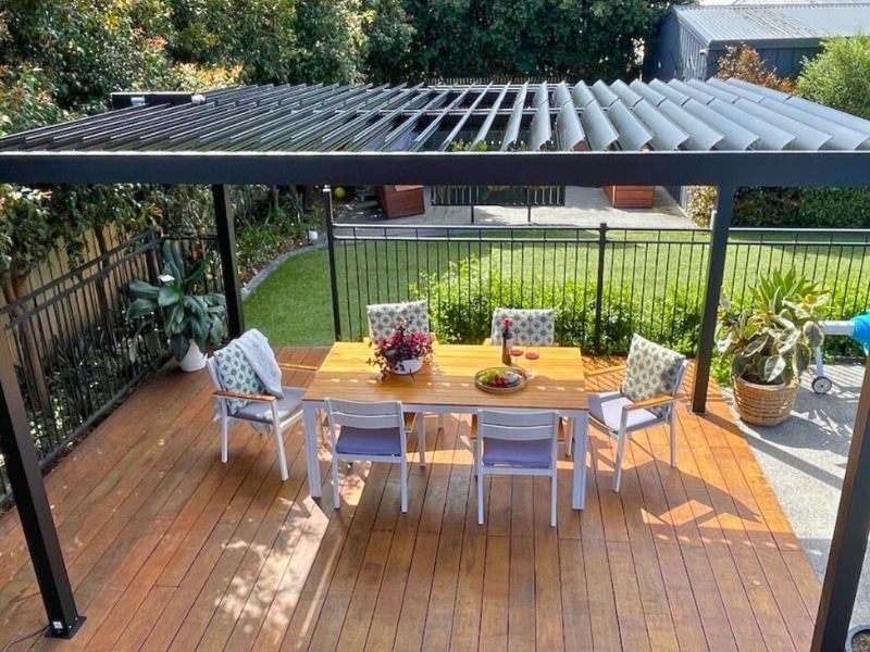 Pergola Styles shown with open-roof aluminium pergola over timber deck and outdoor dining setting.