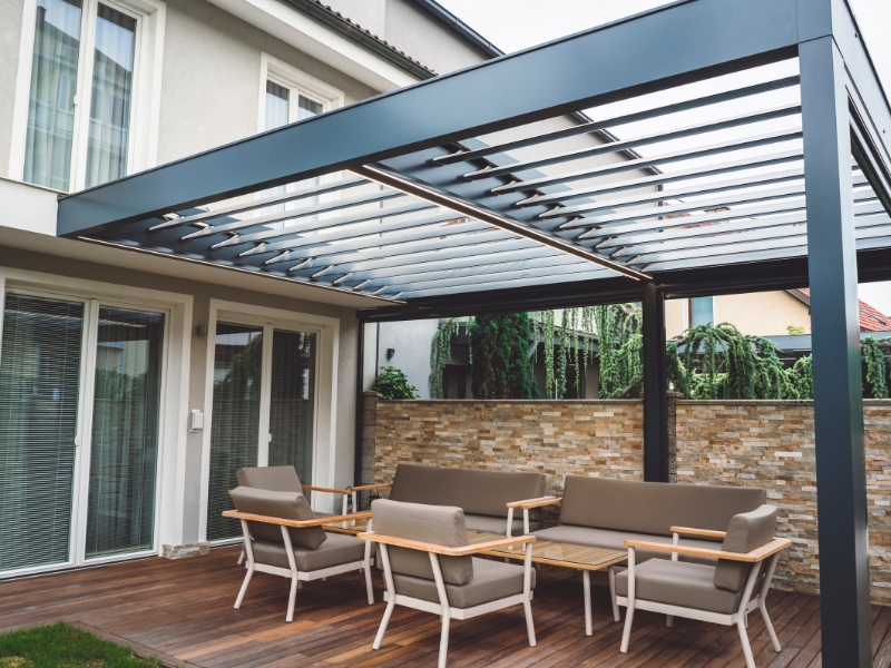Modern patio with outdoor seating area under pergola with optimal pergola dimensions.