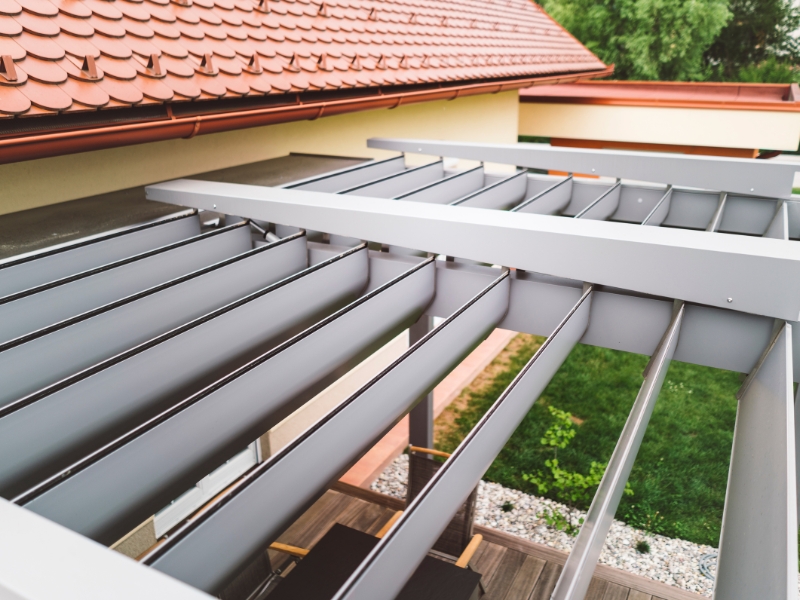 Steel roof louvers and beams showing essential parts of a pergola in modern home installation.