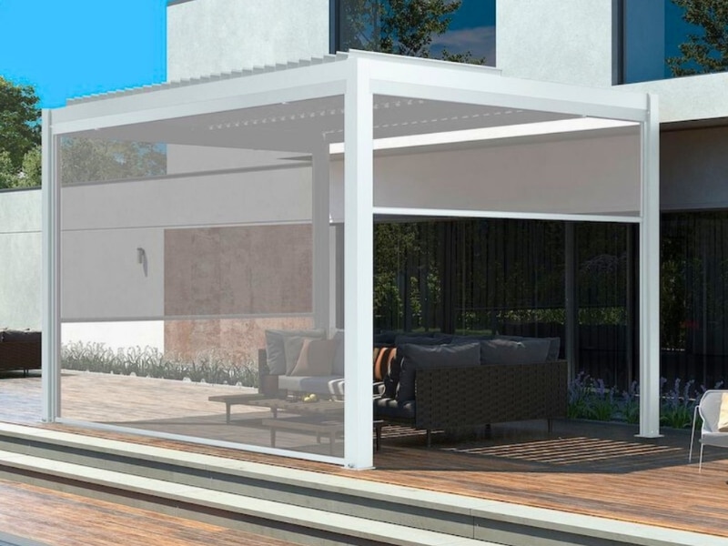 Pergola Measurements displayed on white pergola with privacy screens over timber deck lounge.