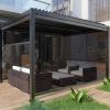 Modern black manual pergola with louvre roof and outdoor wicker seating, showcasing elegant and functional manual pergolas.