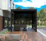 Side view of modern black pergola with manual pull up screens, providing adjustable outdoor privacy and shade beside a pool.