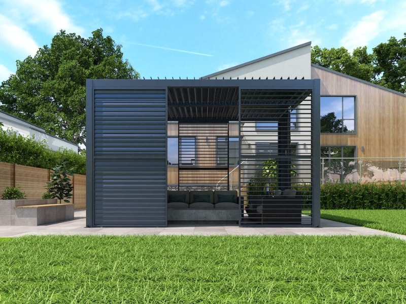 Modern enclosed steel pergola with slatted privacy panels in a landscaped backyard outside a contemporary Australian home