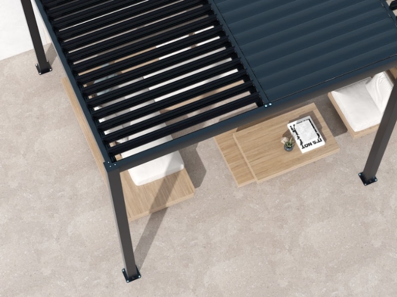 Pergola installation cost shown with black louvre roof over outdoor seating and wooden tables.