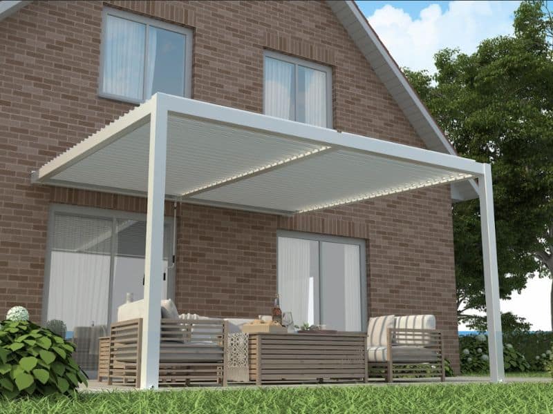 Open pergola designs attached to brick house with white frame and outdoor seating area.