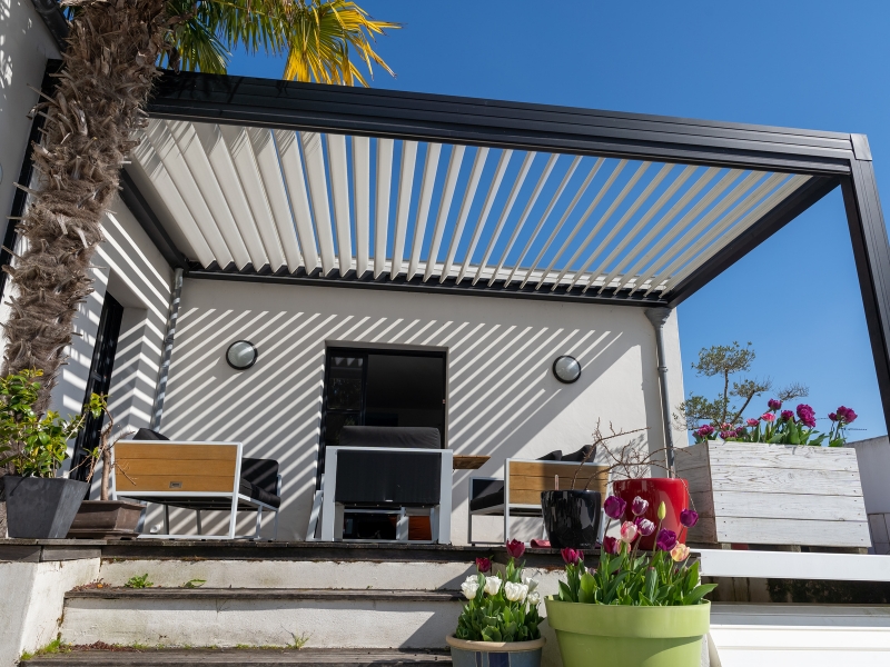Contemporary patio shade achieved by attaching pergola to house.
