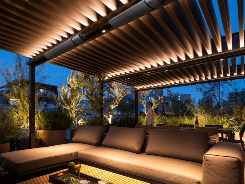 Prefabricated Pergolas with LED lighting creating a stylish outdoor lounge at night.