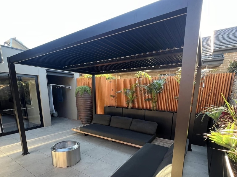 Contemporary pergola constructed from diy pergola plans above modern outdoor lounge area.