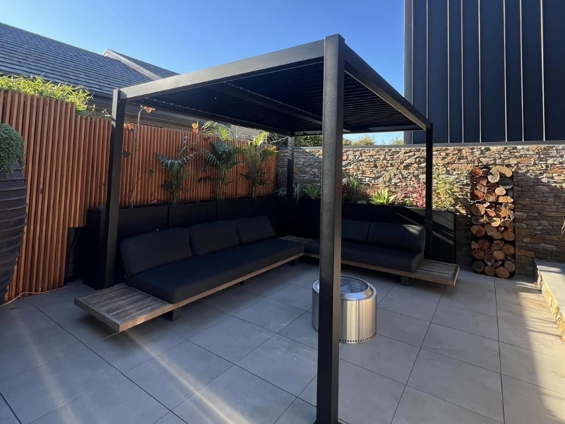 Outdoor patio pergola created using diy pergola plans with built-in seating.