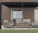 Modern black pergola kits over outdoor seating area with timber furniture against brick house wall