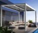Modern outdoor lounge under white manual pergolas with slatted roof beside glass walls and poolside deck
