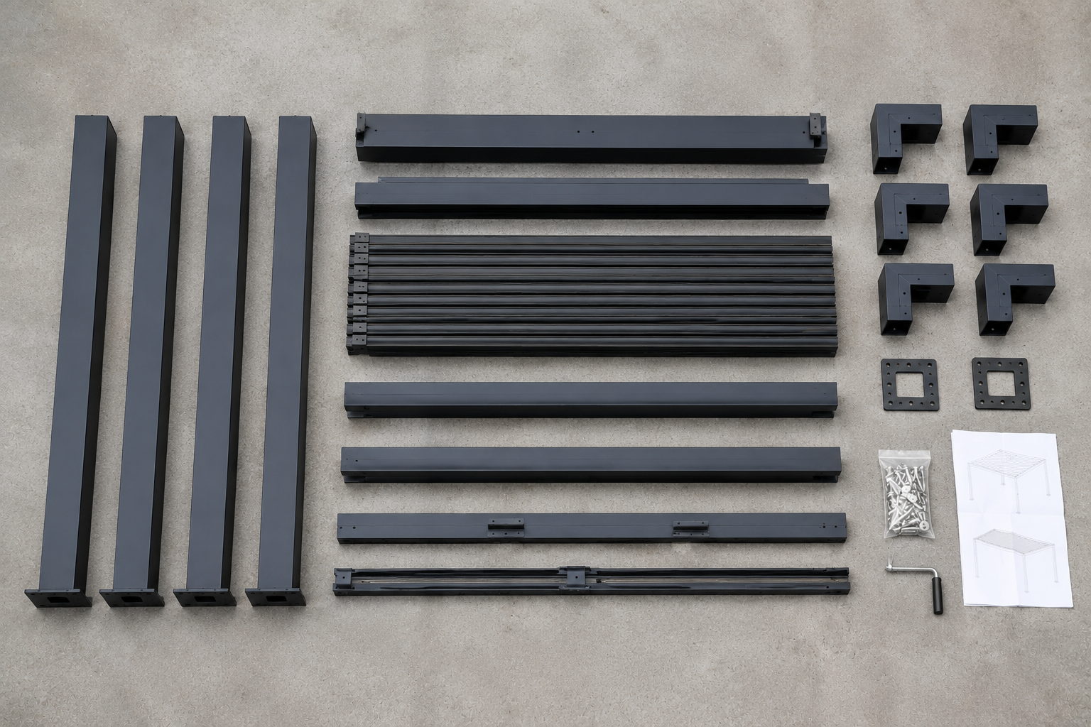 Aluminium pergola kit components laid out on a driveway before assembly